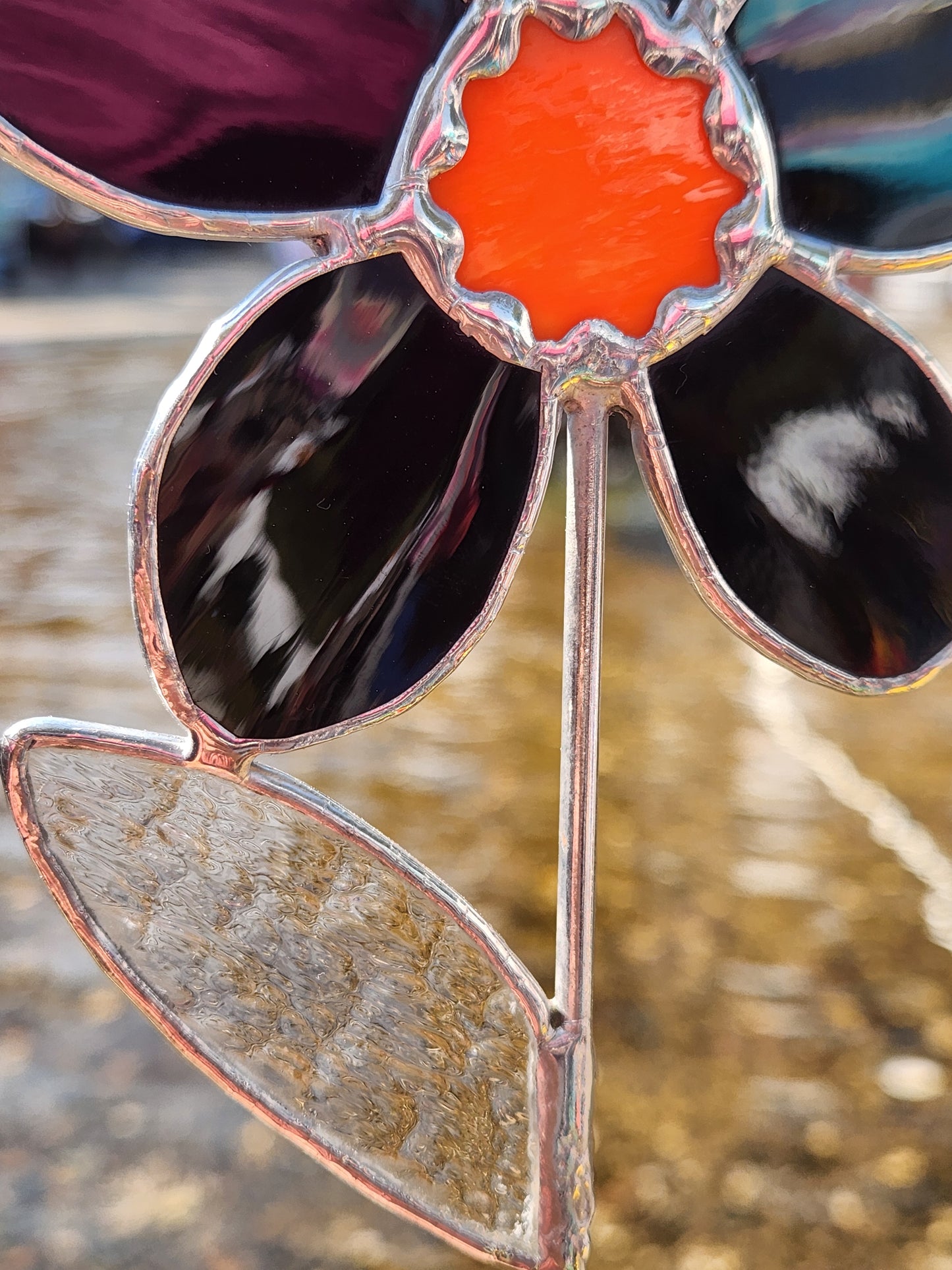 Black Waterglass Stained Glass Daisy Plant Stake with Orange Scallop Center